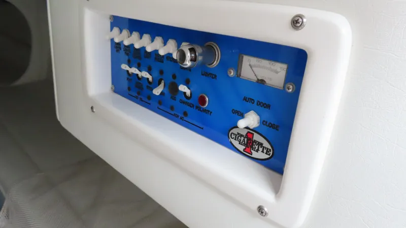 Slide: The Image of Control panel of a 2004 Cigarette 42 Tiger boat with switches and indicators. - 19