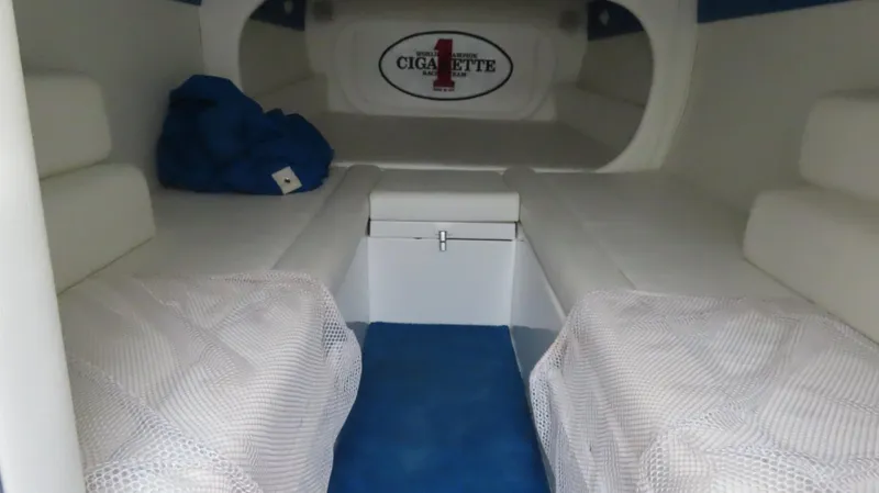 Slide: The Image of Interior of 2004 Cigarette 42 Tiger boat with white seating and blue accents. - 21