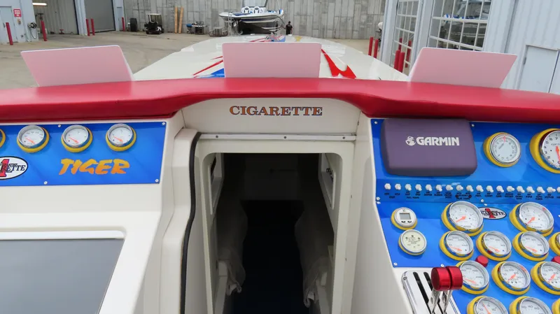 Slide: The Image of 2004 Cigarette 42 Tiger boat dashboard with gauges and Garmin equipment. - 26