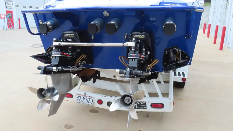 Slide: The Image of 2004 Cigarette 42 Tiger boat with dual Mercury outboard engines on a trailer. - 28