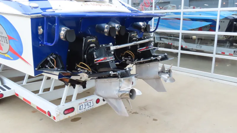 Slide: The Image of Rear view of a 2004 Cigarette 42 Tiger boat with dual engines on a trailer. - 29
