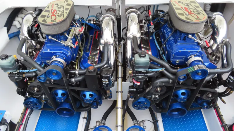 Slide: The Image of Twin blue engines in a 2004 Cigarette 42 Tiger boat, showcasing detailed mechanical components. - 4