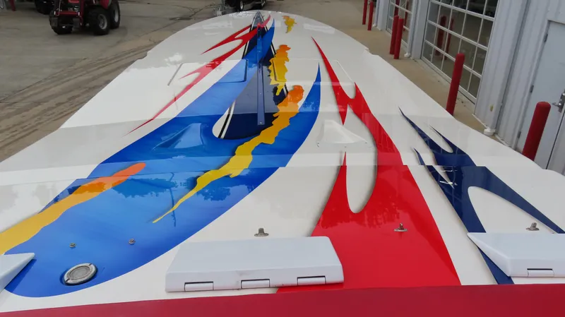 Slide: The Image of 2004 Cigarette 42 Tiger boat with vibrant red, blue, and yellow graphics on deck. - 5