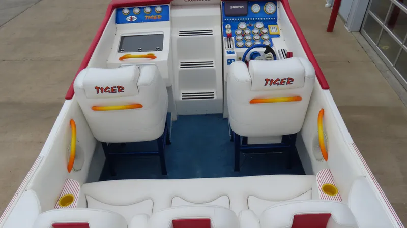 Slide: The Image of 2004 Cigarette 42 Tiger boat interior with white seating and colorful dashboard. - 7