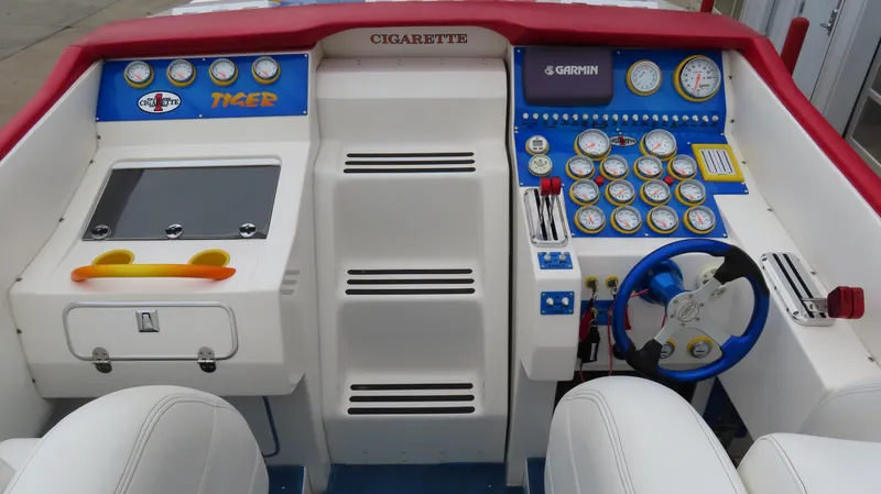 Slide: The Image of 2004 Cigarette 42 Tiger boat dashboard with gauges, steering wheel, and control panels. - 8