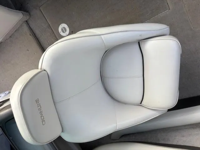 Slide: The Image of White leather seat in a 1999 Crownline 202 boat interior. - 12