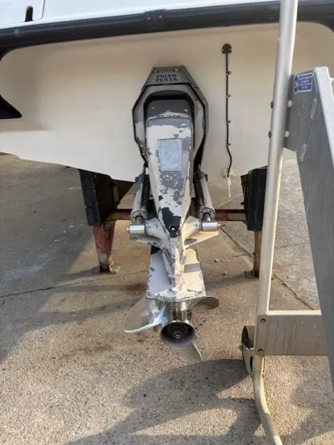 Slide: The Image of 1999 Crownline 202 boat stern drive on a trailer, showing propeller and lower unit. - 13