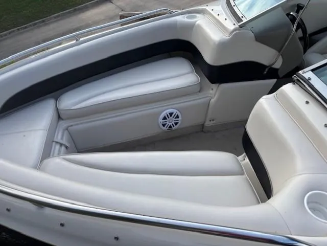 Slide: The Image of 1999 Crownline 202 boat interior with white seating and speaker detail. - 5