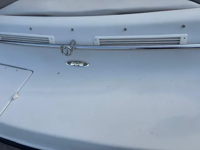 Slide: The Image of 1999 Crownline 202 boat stern with chrome rail and logo detail. - 9