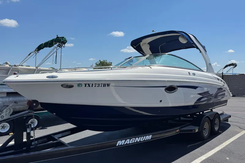Slide: The Image of 2012 Chaparral 267 SSX boat on trailer under clear blue sky. - 0