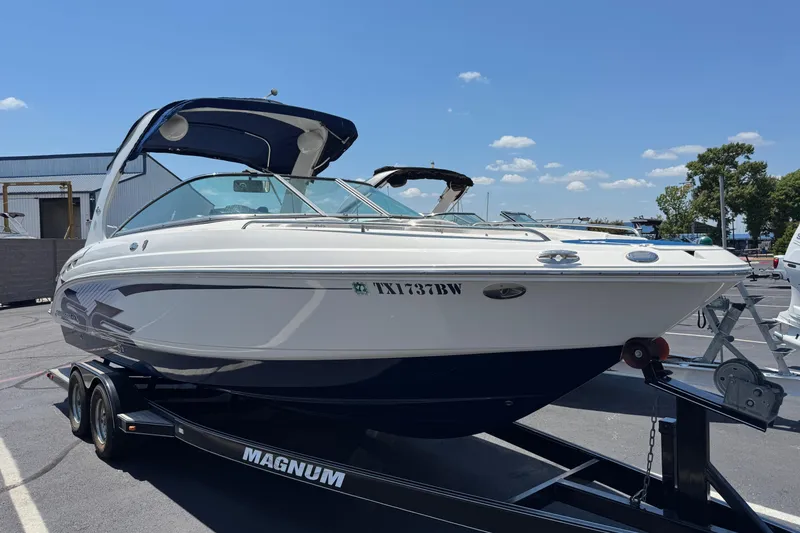 Slide: The Image of 2012 Chaparral 267 SSX boat on trailer under clear blue sky. - 1
