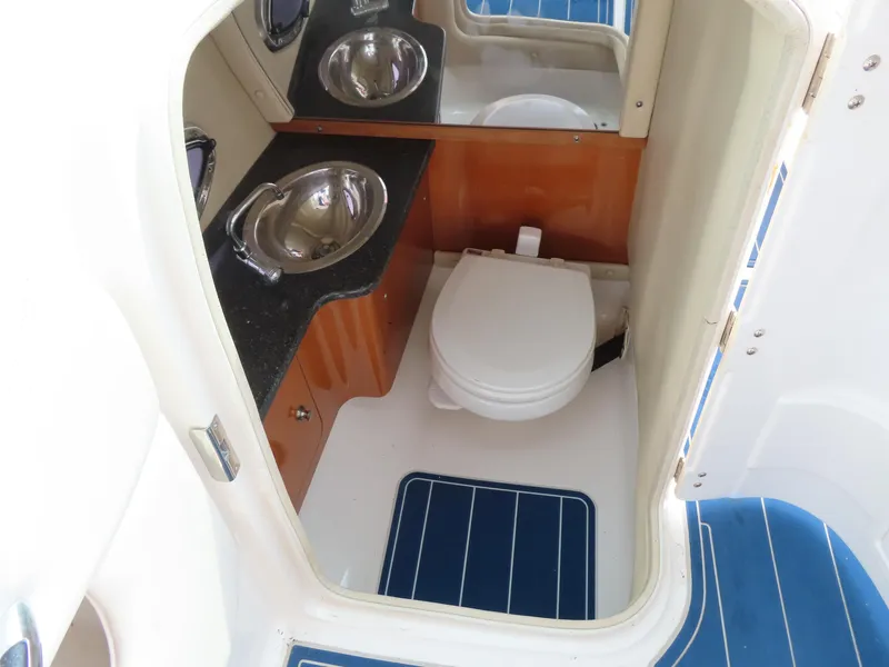 Slide: The Image of 2012 Chaparral 267 SSX boat interior with toilet and sink. - 11