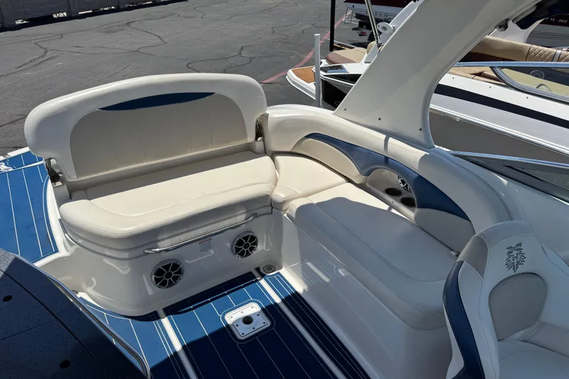 Slide: The Image of 2012 Chaparral 267 SSX boat interior with white and blue seating, featuring built-in speakers. - 5