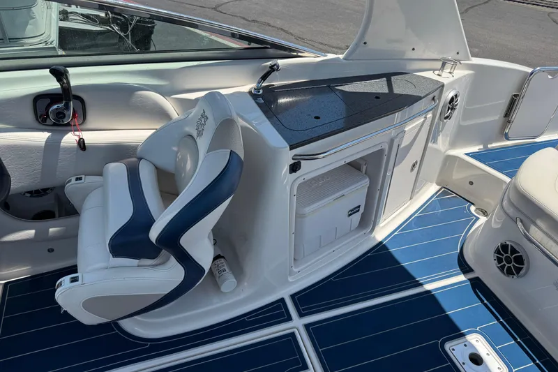 Slide: The Image of 2012 Chaparral 267 SSX boat interior with blue flooring and white seating. - 6
