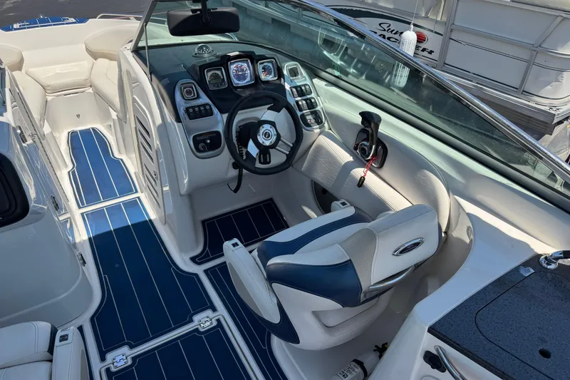 Slide: The Image of Interior of a 2012 Chaparral 267 SSX boat with modern dashboard and seating. - 7