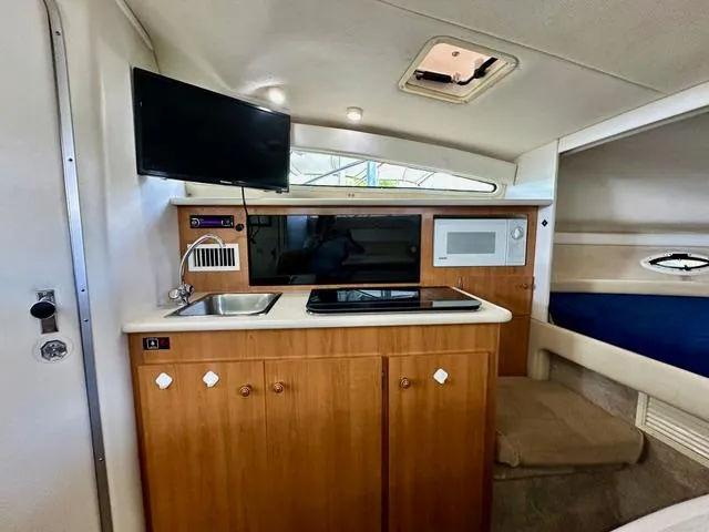 Slide: The Image of Interior of 2001 Bayliner 2855 Ciera boat with kitchenette and TV. - 12