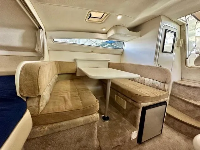 Slide: The Image of 2001 Bayliner 2855 Ciera cabin interior with beige seating and dining table. - 13