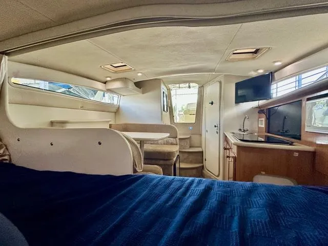 Slide: The Image of Interior of 2001 Bayliner 2855 Ciera boat, featuring cozy seating and modern amenities. - 19