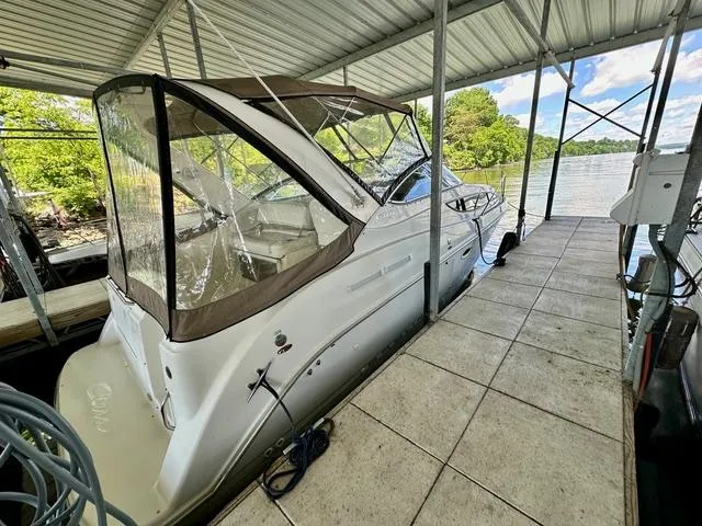 Slide: The Image of 2001 Bayliner 2855 Ciera docked under a covered marina with scenic lake view. - 4
