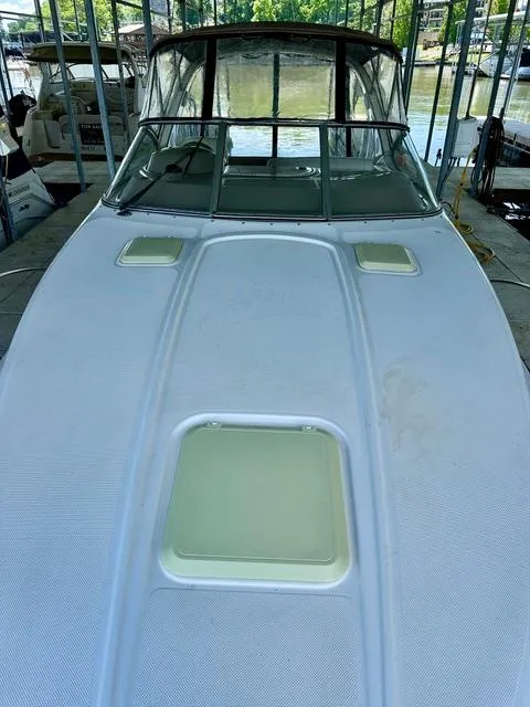 Slide: The Image of 2001 Bayliner 2855 Ciera boat docked, featuring a sleek white deck and windshield. - 5