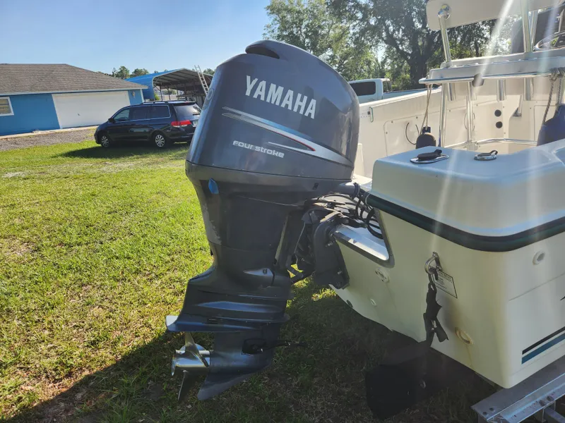 Slide: The Image of 2005 Key Largo 210 CC boat with Yamaha outboard motor on grassy area. - 11