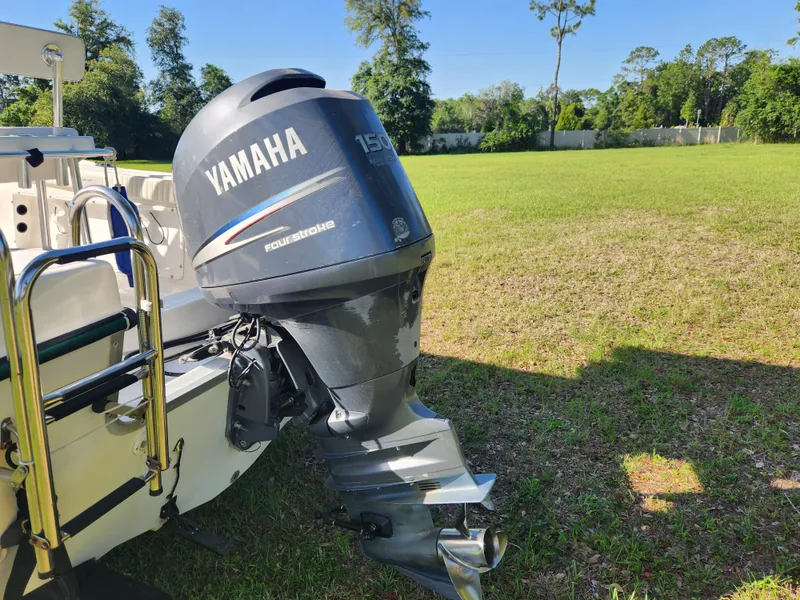 Slide: The Image of 2005 Key Largo 210 CC boat with Yamaha 150 outboard motor on grassy field. - 12