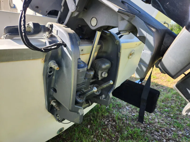 Slide: The Image of Outboard motor mount on a 2005 Key Largo 210 CC boat, showing mechanical components. - 16
