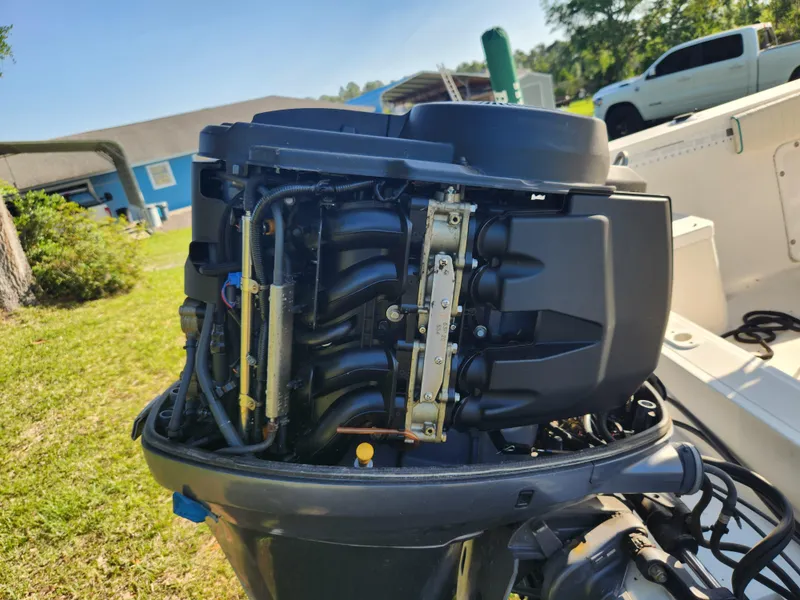 Slide: The Image of Close-up of a 2005 Key Largo 210 CC boat engine, showcasing intricate mechanical details. - 17