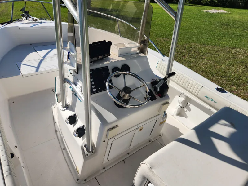Slide: The Image of 2005 Key Largo 210 CC boat interior with steering console and seating. - 24