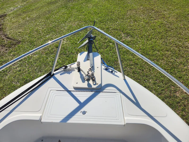Slide: The Image of Bow of 2005 Key Largo 210 CC boat with anchor, on grassy surface. - 40