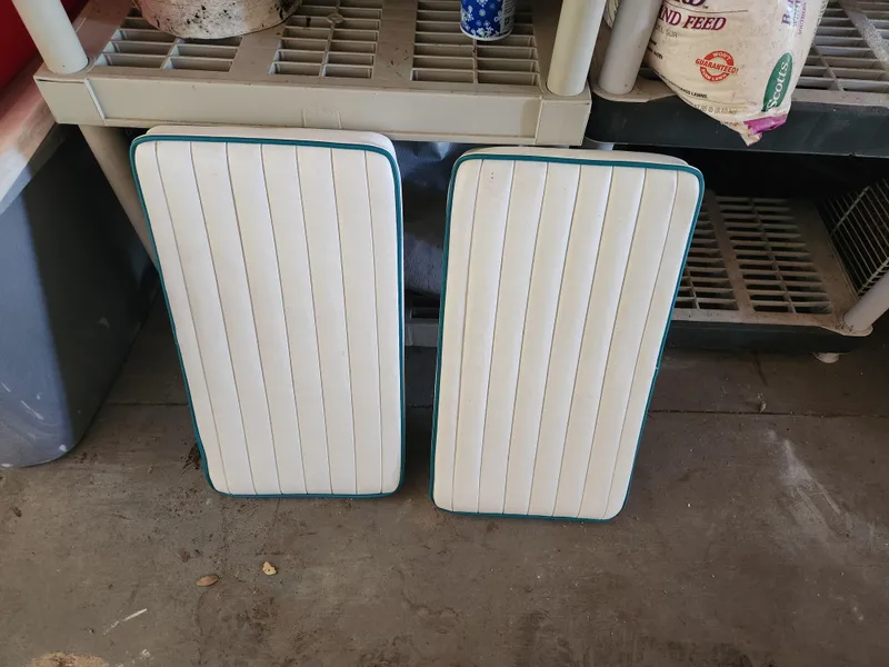 Slide: The Image of Two white boat cushions from a 2005 Key Largo 210 CC, resting on a garage floor. - 43