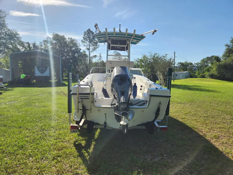 Slide: The Image of 2005 Key Largo 210 CC boat on grass, rear view with outboard motor. - 5
