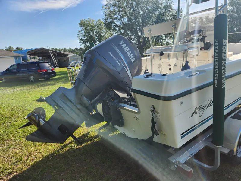 Slide: The Image of 2005 Key Largo 210 CC boat with Yamaha outboard motor on grassy area. - 9