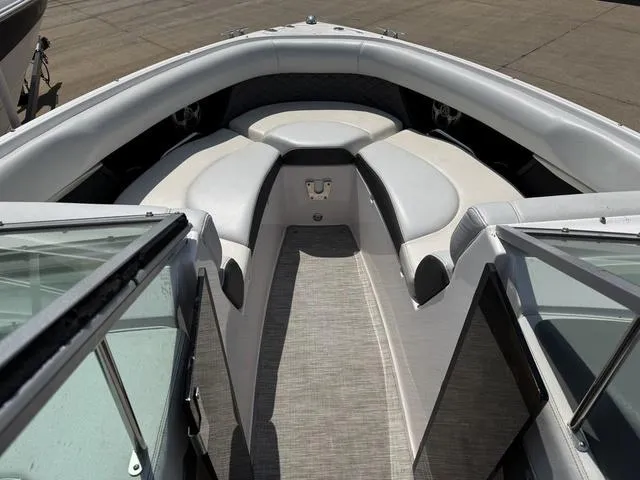 Slide: The Image of 2014 Regal 2300 boat interior with cushioned seating and open deck view. - 16