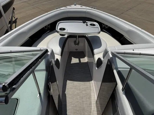 Slide: The Image of 2014 Regal 2300 boat interior with seating and table, viewed from the bow. - 17