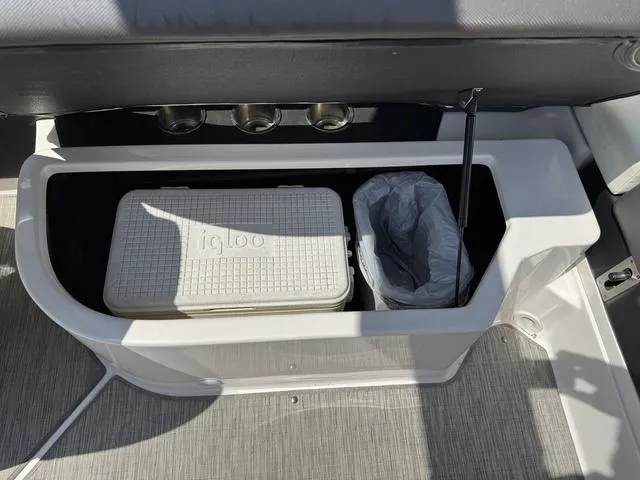 Slide: The Image of 2014 Regal 2300 boat storage with Igloo cooler and trash bin. - 18