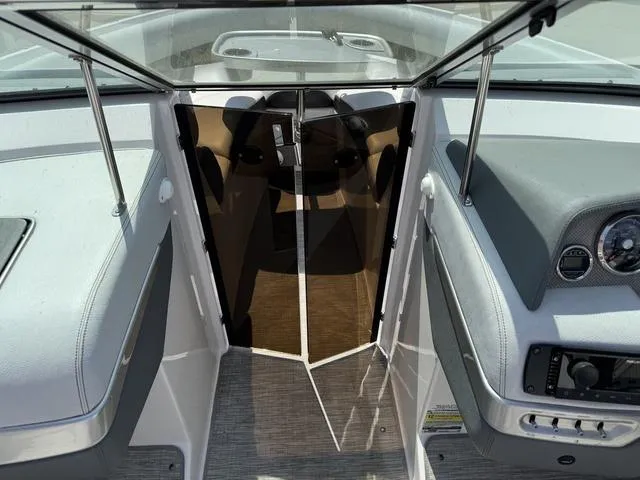 Slide: The Image of 2014 Regal 2300 boat interior with open glass door and dashboard view. - 19