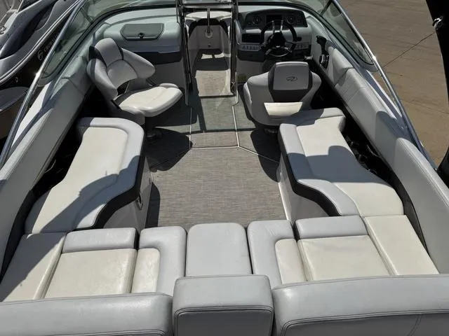 Slide: The Image of 2014 Regal 2300 boat interior with spacious seating and modern dashboard. - 5