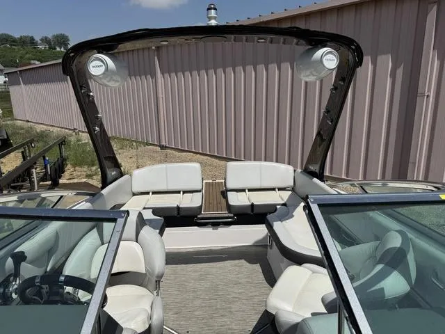 Slide: The Image of 2014 Regal 2300 boat interior with white seating and open windshield. - 9