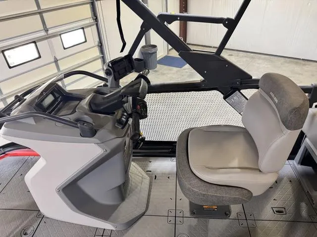Slide: The Image of 2023 Sea-Doo Switch® Sport Compact-170 hp cockpit with steering and seating in a garage setting. - 13