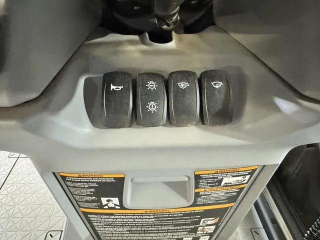 Slide: The Image of Control panel of 2023 Sea-Doo Switch® Sport Compact-170 hp with labeled switches. - 15