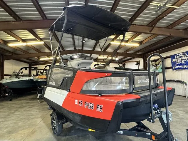 Slide: The Image of 2023 Sea-Doo Switch® Sport Compact-170 hp in a garage, red and black design. - 2