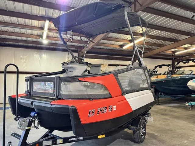Slide: The Image of 2023 Sea-Doo Switch Sport Compact-170 hp in a storage facility, featuring a vibrant red and black design. - 4