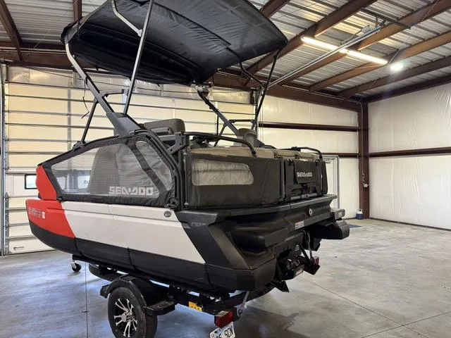 Slide: The Image of 2023 Sea-Doo Switch® Sport Compact-170 hp in a garage, showcasing its sleek design and canopy. - 6