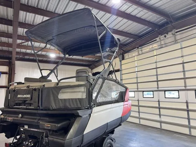 Slide: The Image of 2023 Sea-Doo Switch® Sport Compact-170 hp in a garage, showcasing its sleek design and canopy. - 8
