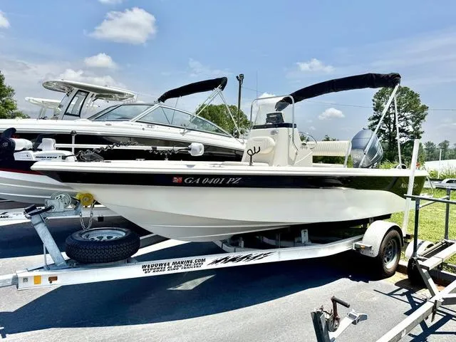 Slide: The Image of 2012 NAUTIC STAR 1810 CC boat on trailer, sunny day, parked outdoors. - 1