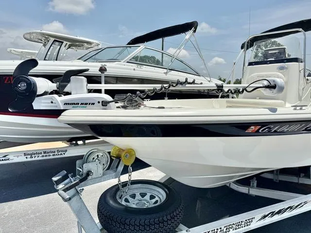 Slide: The Image of 2012 NAUTIC STAR 1810 CC boat on trailer, featuring Minn Kota trolling motor. - 2
