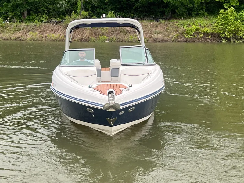 Slide: The Image of 2011 Rinker 276 Captiva Bowrider on calm water, front view. - 12