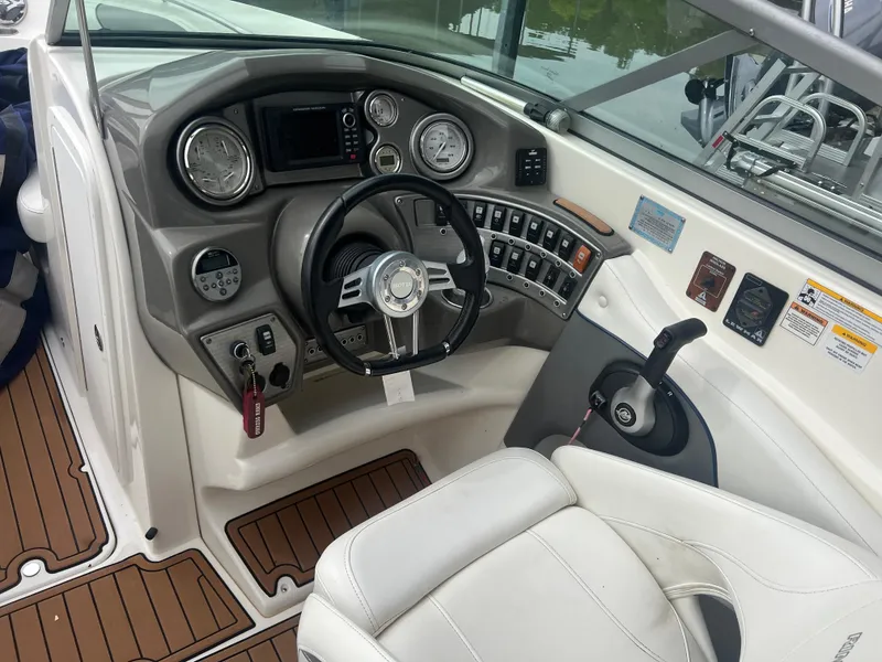 Slide: The Image of 2011 Rinker 276 Captiva Bowrider dashboard with steering wheel and controls. - 14