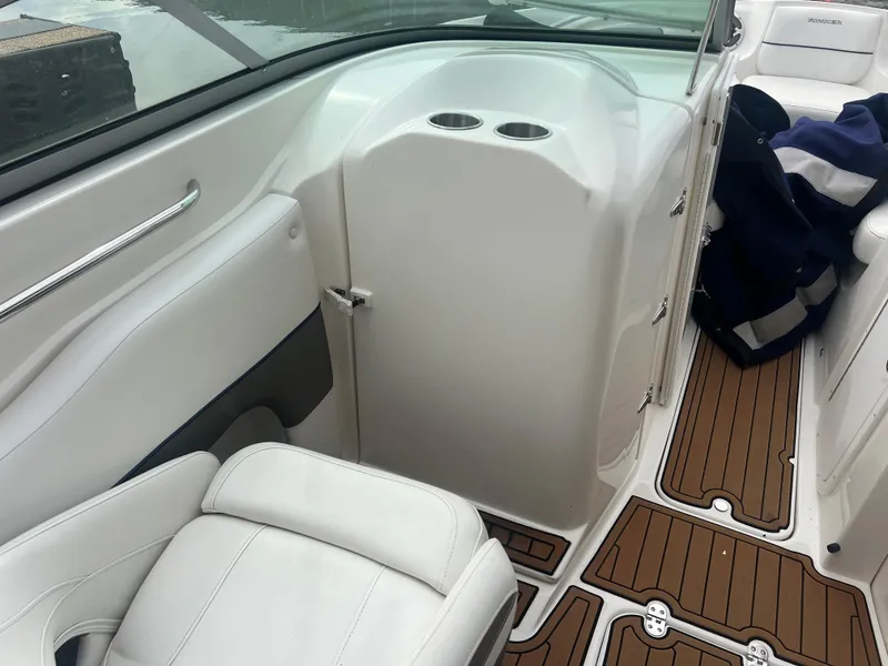 Slide: The Image of 2011 Rinker 276 Captiva Bowrider interior with white seating and wood-patterned flooring. - 15